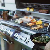 Luxury outdoor grill station with multiple cooking surfaces for backyard entertainment spaces