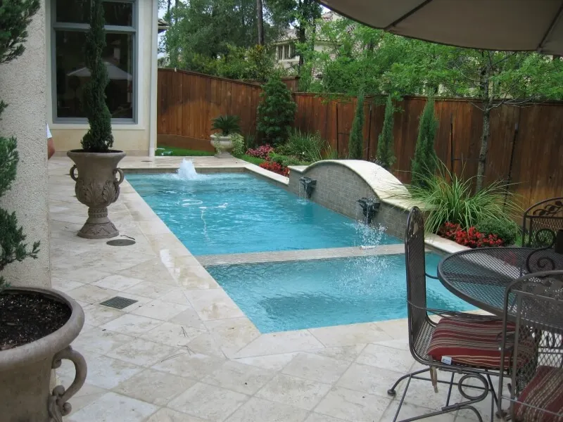Custom geometric luxury backyard pool with water features and spa in Woodlands