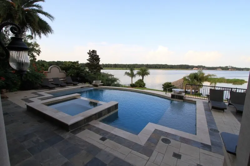 Luxury geometric pool with spa and waterfront views in Woodlands custom backyard design