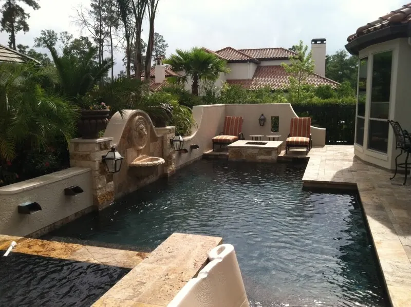 Luxury backyard pool with Mediterranean design, spa, fire pit, and outdoor entertainment patio