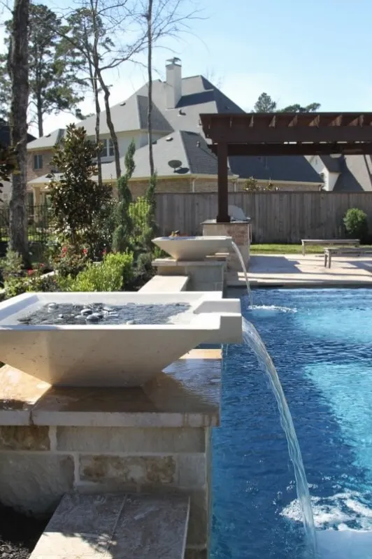 Luxury backyard pool with water bowl features and modern outdoor living space design